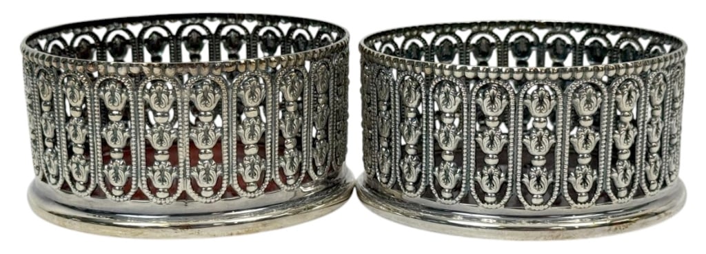 Pr Topazio Casquinha Silvered Wine Bottle Coasters: Pair of Topazio Casquinha Portuguese openwork silver-plated wine bottle coasters with ornate pierced sides and polished rims. Each base is fitted with a tortoiseshell style amber colored liner. Circa: