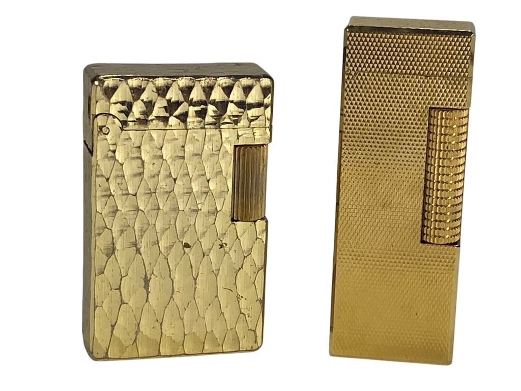 Dunhill Swiss & Royal Castle Lighters 2pc LOT: Pair of vintage lighters including a Swiss-made Dunhill in gold-tone engine-turned design, stamped 'Made in Switzerland, Dunhill, Patented US RE24163'; together with a Royal Castle lighter with hammer