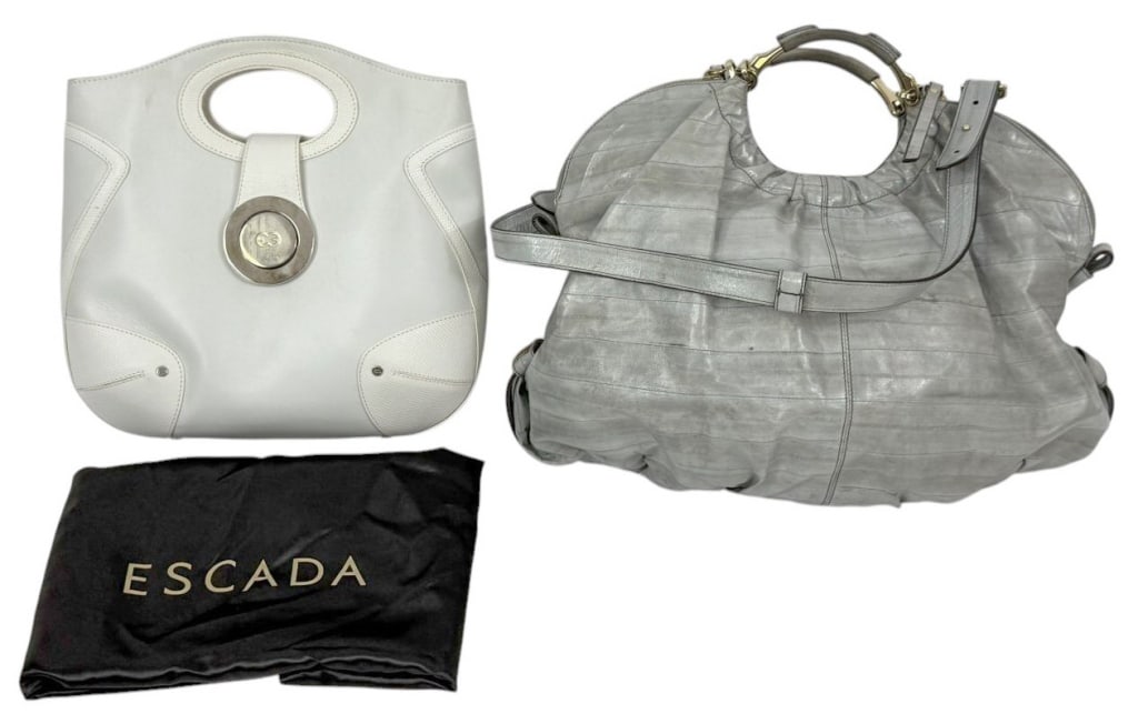 Escada White Leather Tote, Gray Slouch Bag 2pc LOT: Lot of two Escada Italian handbag purses. To include a white leather structured tote with circular cut-out handles, tab closure, and oversized silver-tone medallion accent engraved with the Escada bra