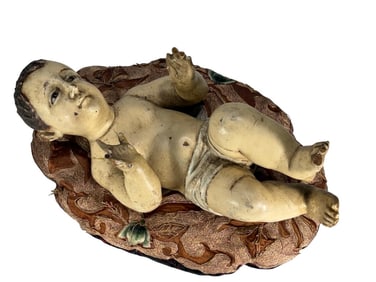 Antique Wooden Baby Jesus on Silk Cushion