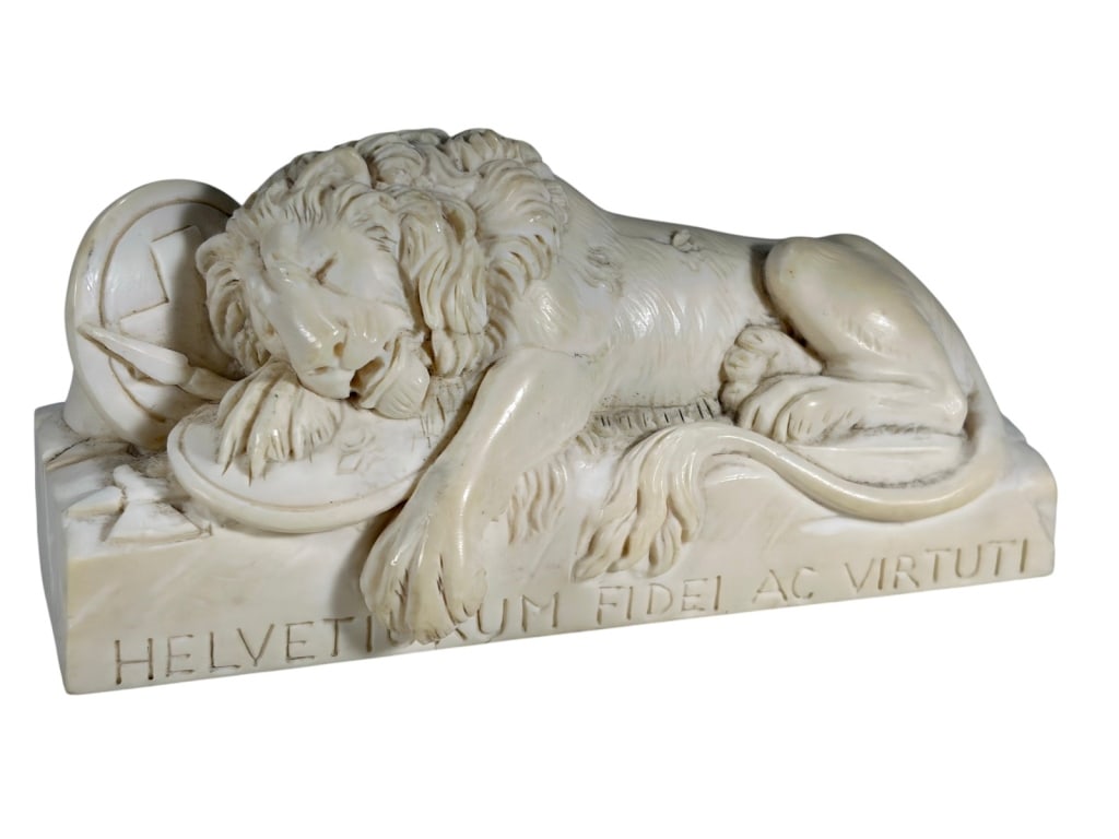 Sculpture of the Lion of Lucerne Possibly Bone: Small carved sculpture of the Lion of Lucerne monument, showing a reclining lion on shields. Inscribed 'HELVETIORUM FIDEI AC VIRTUTI' on the base.Dimensions: 2.25 X 4.75 X 1.75 in. Condition: Good