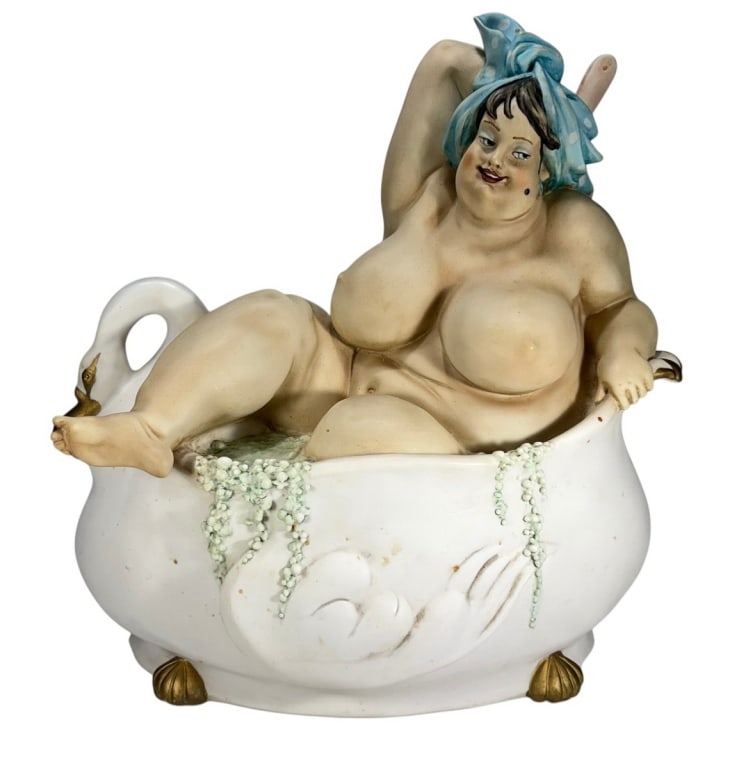 Italian Design Big Lady Taking Bath Resin Statue: Resin statue of a nude lady in a swan-shaped tub with headscarf, bath brush, bead 'bubbles,' and gold accents. Underside is stamped 'Made in China, Designed in Italy.'Dimensions: 14 X 12.5 X 7.5 in. C