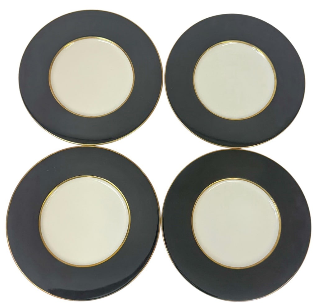 Ralph Lauren Ramsey Black & Gold Plates 4pc SET: Ralph Lauren, set of four 'Ramsey' charger plates, made in Italy. Each charger features a bold black rim accented with a refined gold border, framing a white central well. Originally retailing at $150