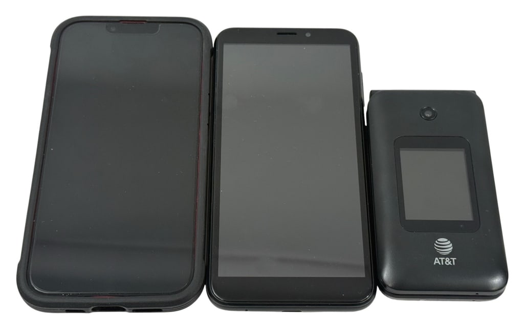 AT&T iPhone, Smartphone & Hotspot 3pc LOT: This lot includes an IPhone 13 128 GB, an Android Smartphone and an AT&T flip phone. The largest measures approximately 6 inches tall by 3 inches wide by 0.5 inches deep. Condition: Good overall condi