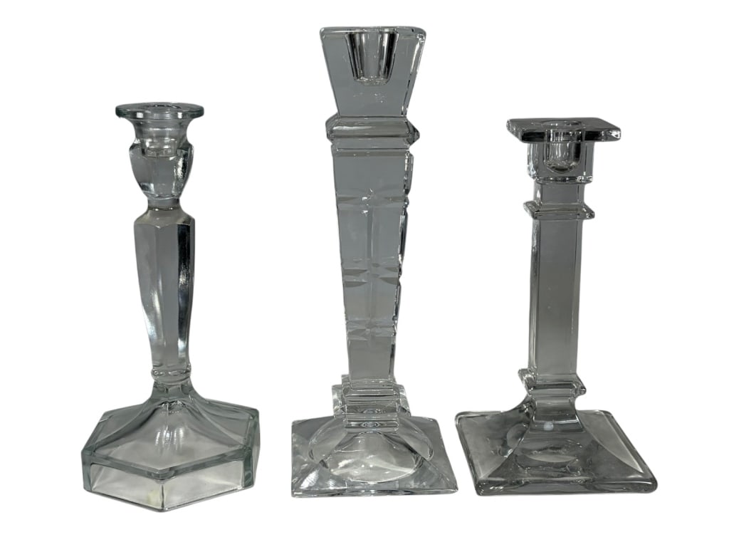 Clear Crystal & Glass Candlesticks 3pc LOT: Three candlesticks with faceted stems and clear polished surfaces, in assorted geometric base designs including hexagonal and square. The largest measures approximately 10 inches tall by 3.5 inches wi