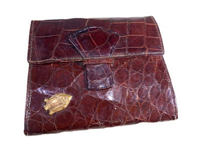 1930s Alligator & 18 Karat Gold Wallet: Dark alligator wallet with an 18 karat gold shield plaque engraved with monogram and striped fabric-lined interior pockets. The measurements provided refer to the wallet in its closed