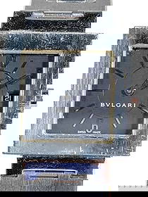 Bulgari Quadrato Stainless Steel Black Watch: Bvlgari Quadrato stainless steel watch with black dial, date window, and silver-tone hands. Engraved 'BVLGARI,' marked 'Fabrique en Suisse,' 'Stainless Steel,' and 'Swiss Made.' Quartz movement. Case