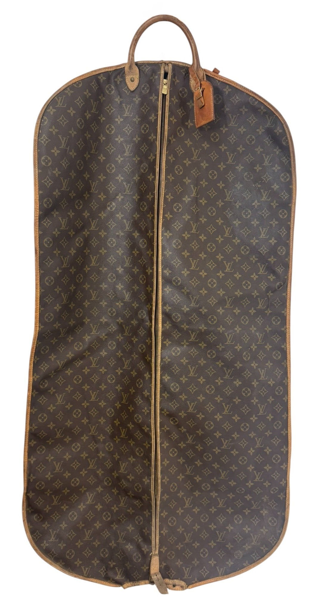 Vintage Louis Vuitton Monogram Canvas Garment Bag: Vintage Louis Vuitton monogram coated canvas leather travel garment bag. Made in France. The bag features dual rolled leather handles, a full-length brass zipper closure, and a matching leather name t