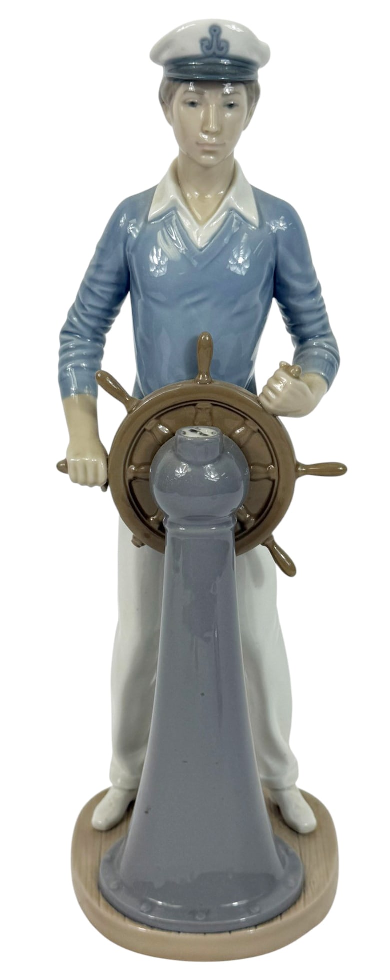 Lladro 'Young Helmsman' Porcelain #5221 Figurine: Lladro Spanish porcelain figurine titled 'Young Helmsman' (#5221), depicting a young sailor confidently steering a ships wheel. Designer: Juan Huerta. Issued: 1984. Retired: 1991. Stamped marked under