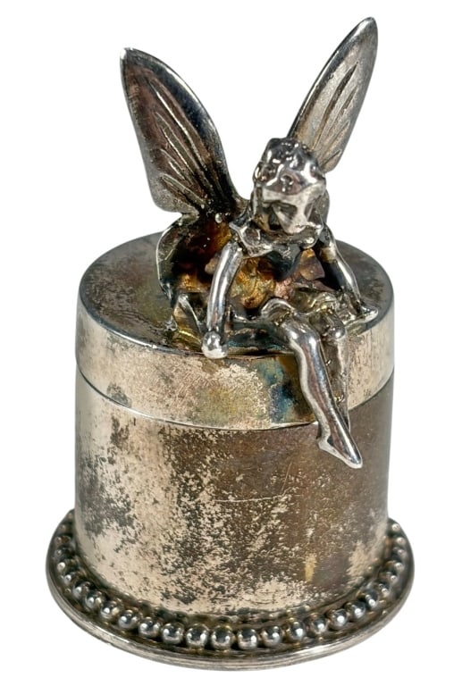 Lunt Sterling Silver 921 Tooth Fairy Mini Box: Miniature sterling silver lidded 'Tooth Fairy' box by Lunt Silversmiths, with seated fairy on domed lid, beaded base rim, and smooth interior. Stamped on the underside Lunt Sterling 925.Dimensions: 1.