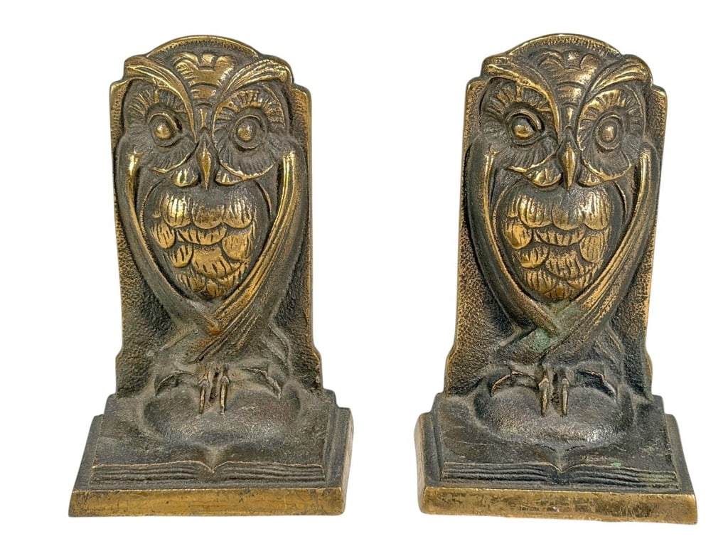 Pair of Ornate Owl Solid Bronze Bookends: Pair of solid bronze bookends featuring stylized owls with incised feather details and large eyes perched on closed books. Both pieces stamped 'Solid Bronze' on the reverse. Each piece measures approx