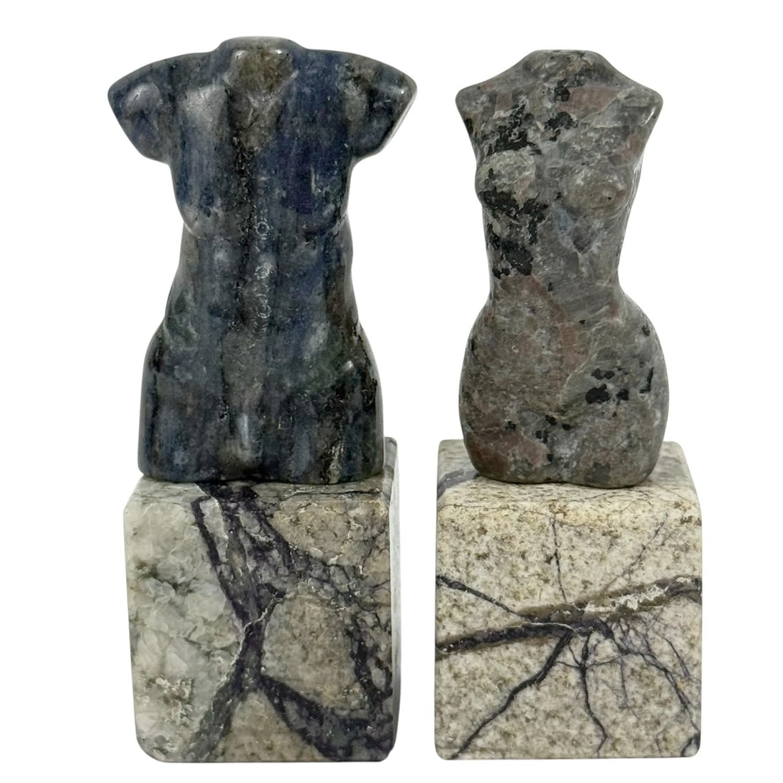 Pair of Morado Opal Stone Nude Torso Sculptures: Pair of hand-carved miniature torso sculptures crafted from Morado opal, also known as Purple Opal. Each figure represents a stylized male and female form. The torsos rest on square Morado opal bases