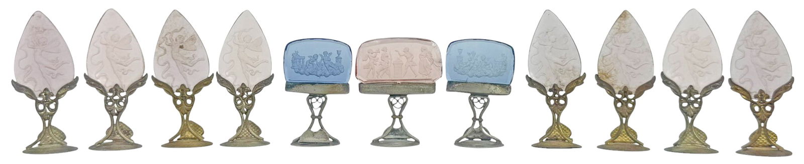 Austrian & Czech Silvered Art Glass Holders 11pcs: Lot of eleven Art Nouveau-style place card holders, crafted with intaglio glass inserts mounted on a decorative silver-tone metal stand. Featuring whimsical pink glass wings etched with fairies (8 tot