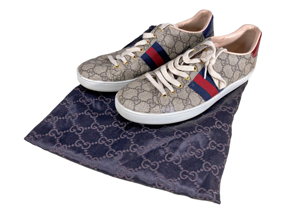 Gucci Supreme Ace Sneakers Unisex Size 40: Pair of unisex Gucci GG Supreme canvas sneakers with red and blue web stripes and metallic snakeskin heel tabs. Includes its dust cover bag. Size 40. Embossed 'GUCCI Made in Italy' inside and on sole.