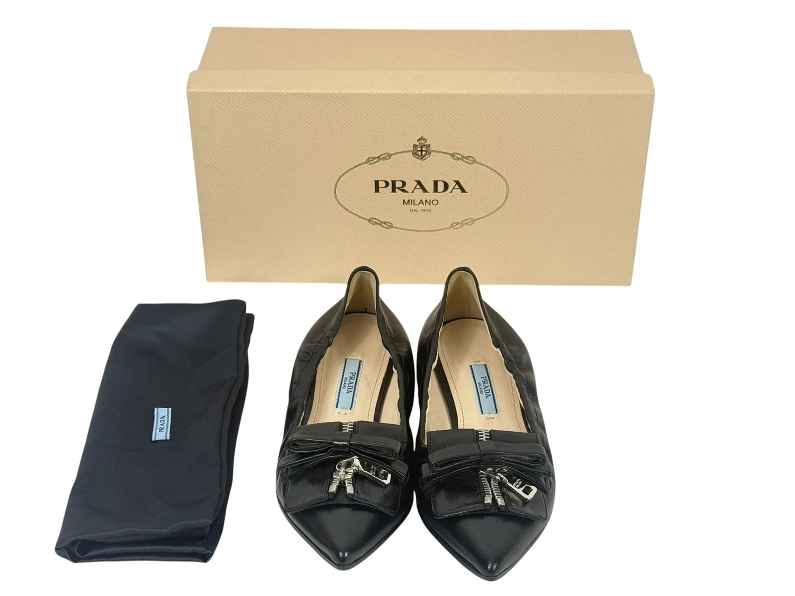 Prada Nappa Leather Ballet Flats Size 36.5 w/ Box: Prada black Nappa leather ballet flats featuring a unique zipper and bow detail across the toe. These flats are made from soft, supple leather with a sleek pointed toe silhouette. Made in Italy. Inclu
