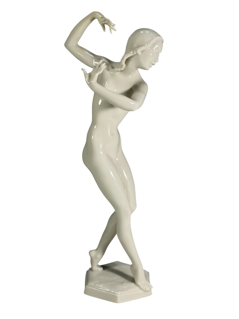 Hutschenreuther Nude Dancer by Werner Figurine: Hutschenreuther porcelain nude dancer by Carl Werner (German, 1895 - 1980), depicting a slender standing female in graceful motion with one arm raised and the other extended. Impressed 'C. Werner' sig