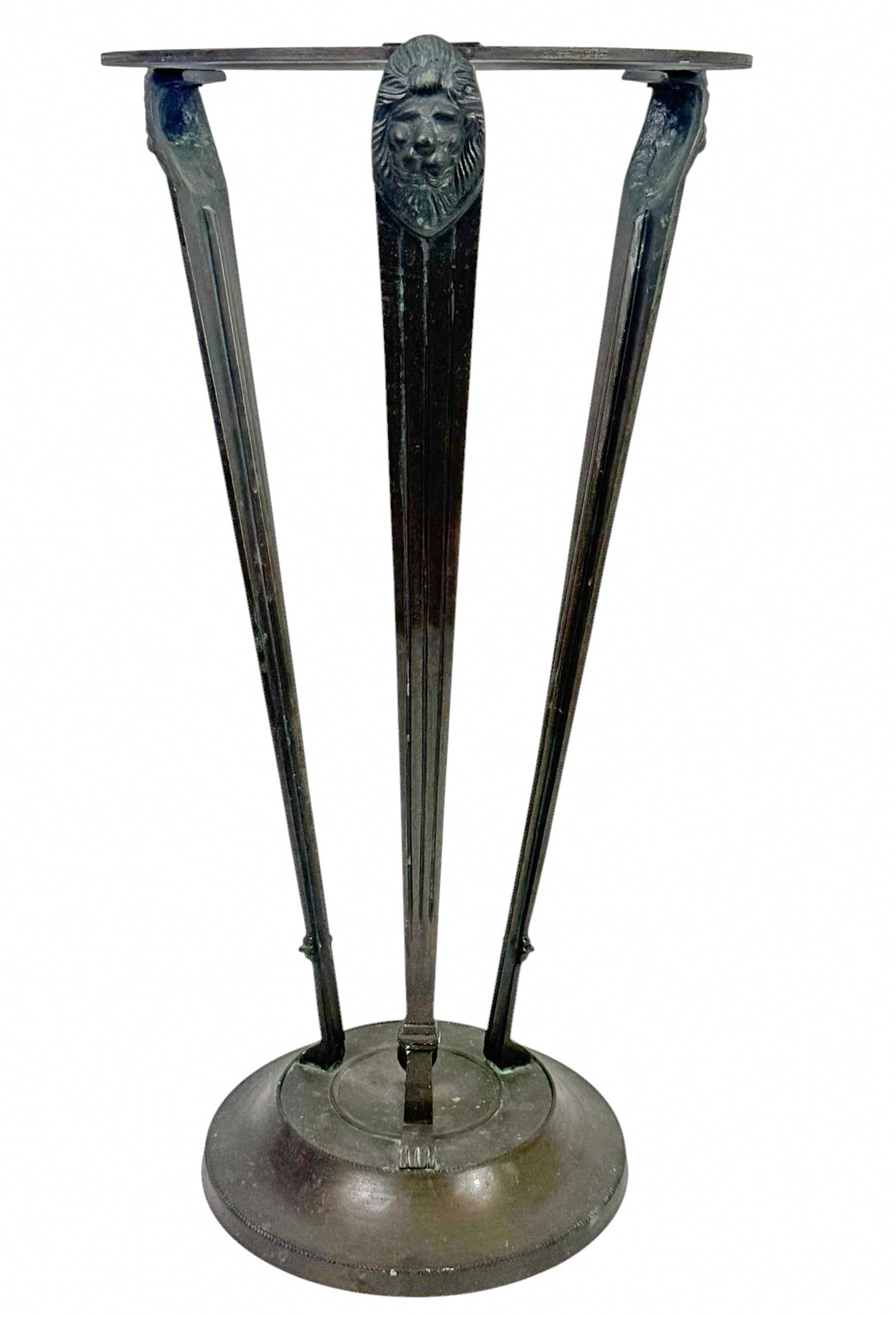Bombay Company Bronze Lion Head Pedestal Stand: Bombay Company cast metal pedestal stand featuring a classic tri-leg design with lion head motifs at the top of each leg. Each leg tapers gracefully from the top ring to the circular base. Circa: Late