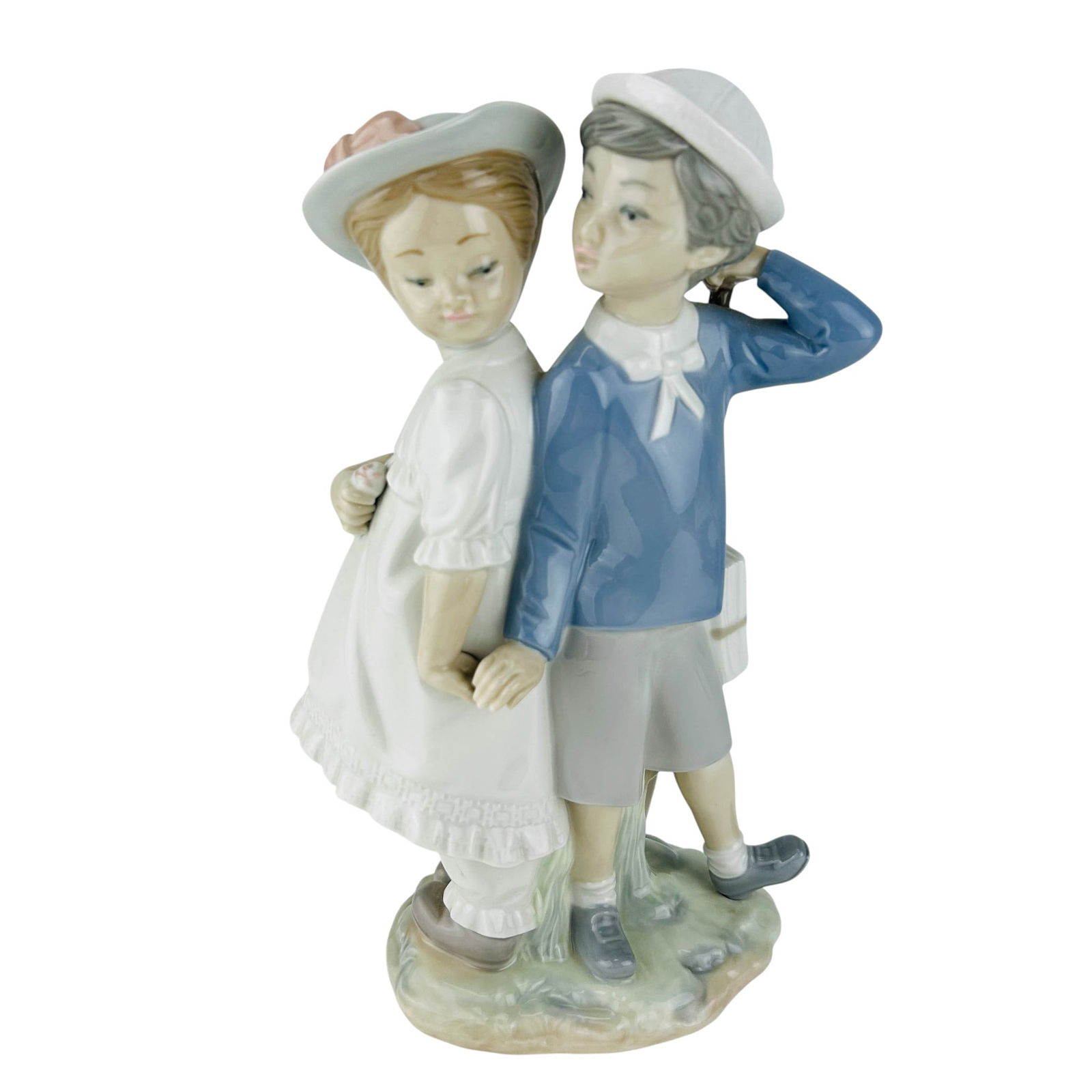 Lladro Spain Puppy Love #1127 Porcelain Figurine: Lladro Spanish Puppy Love model number 1127 hand painted porcelain figurine. Sculptor Vincente Martinez. Produced between 1971-1996. Depicts a young boy and girl standing back-to-back in an innocent p