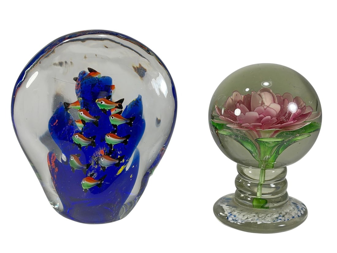 Murano Glass Aquarium & Flower Paperweights 2pcs: Pair of blown Italian Murano art glass paperweights: one designed as an aquarium with millefiori fish in cobalt glass, the other with pink flower and green leaves in clear glass. The largest measures