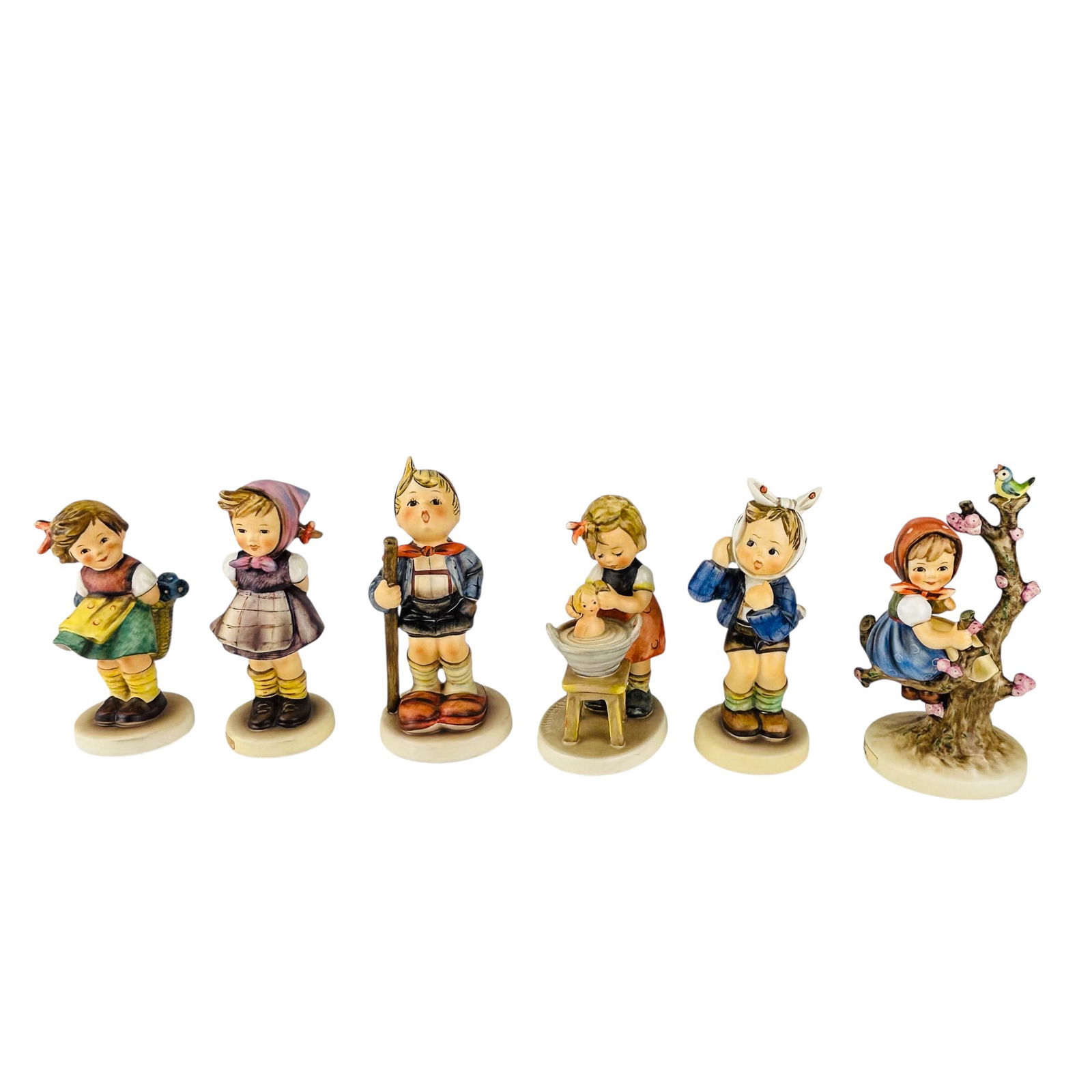 Hummel Goebel German Porcelain Figurines 6pc LOT: Collection lot of six Hummel Goebel Germany ceramic porcelain figurines. Names include Apple Tree Girl. Measure from approximately 5" x 2.25" x 2.75" to approximately 6.25" x 3.25" x 2.75". Each marke
