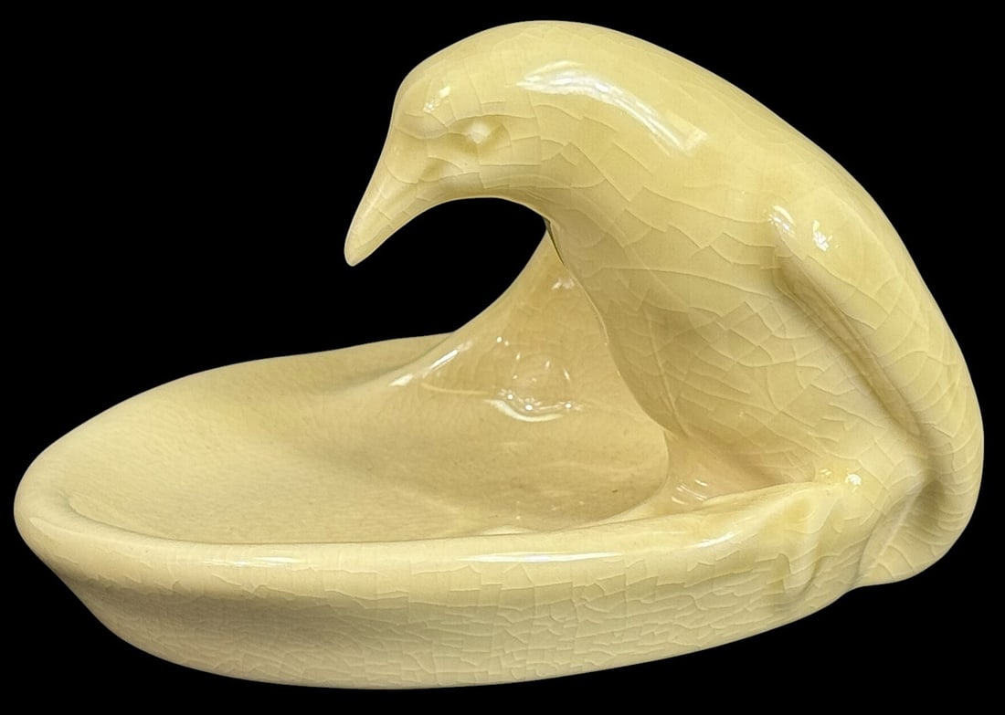 Vintage Czechoslovakian Glazed Ceramic Bird Dish: Vintage Art Deco-style ceramic dish features a stylized bird perched over a shallow bowl, rendered in a soft ivory glaze with prominent craquelure. Crafted in the style of Royal Dux or a similar Czech