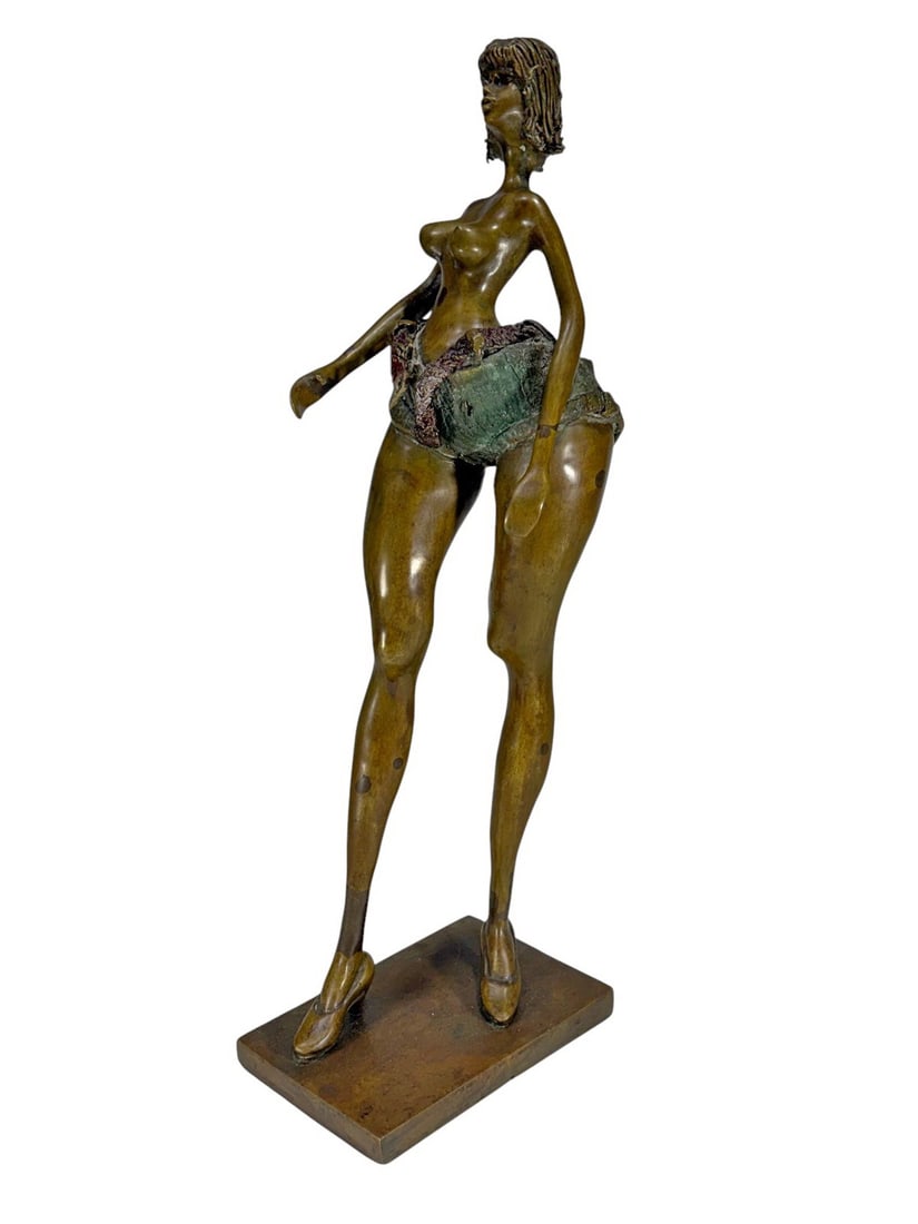 Nude Woman Bronze Sculpture SIGNED: Bronze sculpture of a stylized nude woman with verdigris shorts and warm brown patina, signed Garza, mounted on a rectangular base.Dimensions: 16.5 X 5.75 X 4.25 in. Condition: Good overall condit