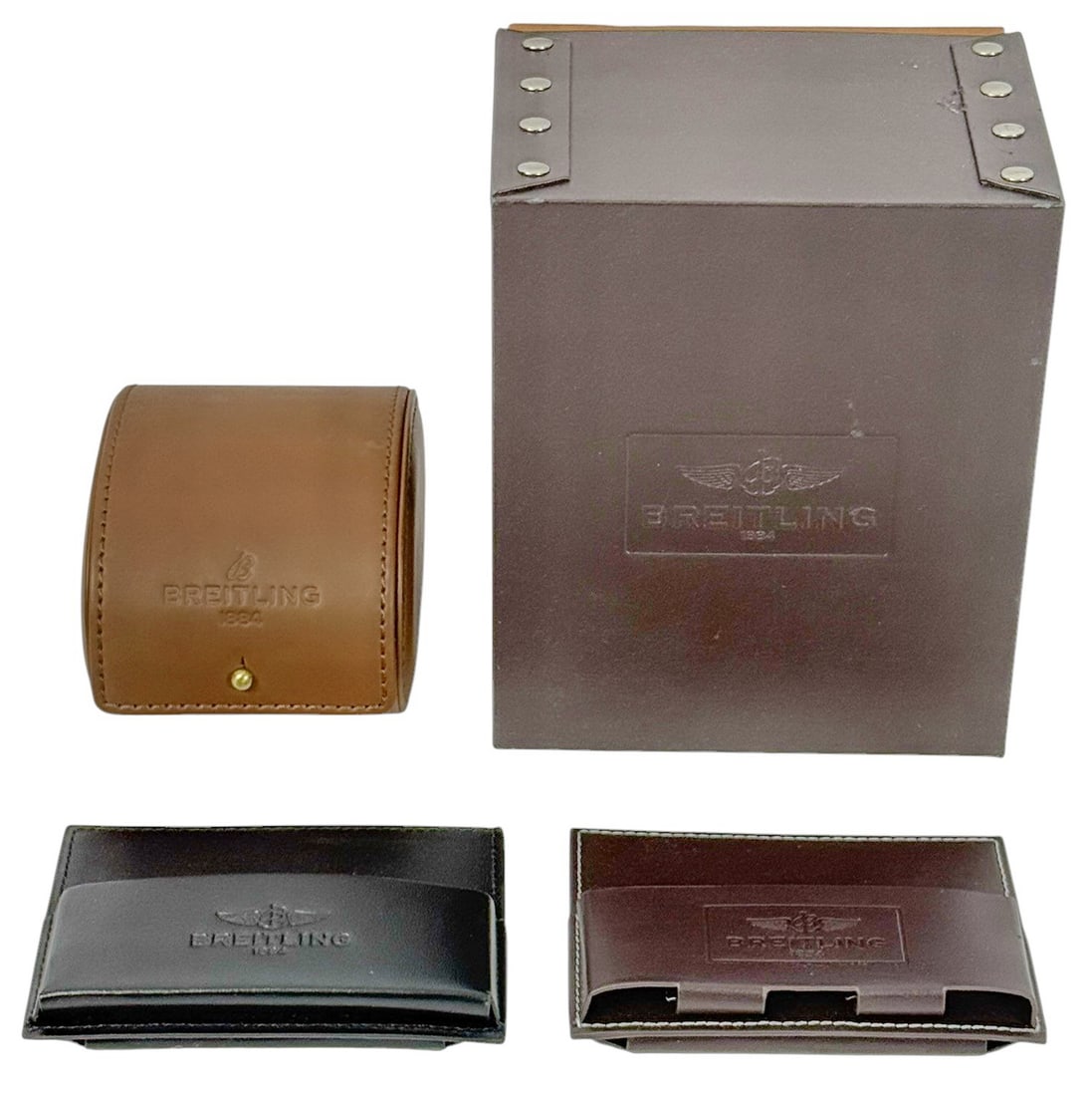 Breitling Leather Watch Boxes & Accessories 4pcs: Breitling watch packaging and accessory lot. This group includes (2) leather watch cases (one having its outer presentation box) and (2) Breitling document pouches. The largest piece measures approxim