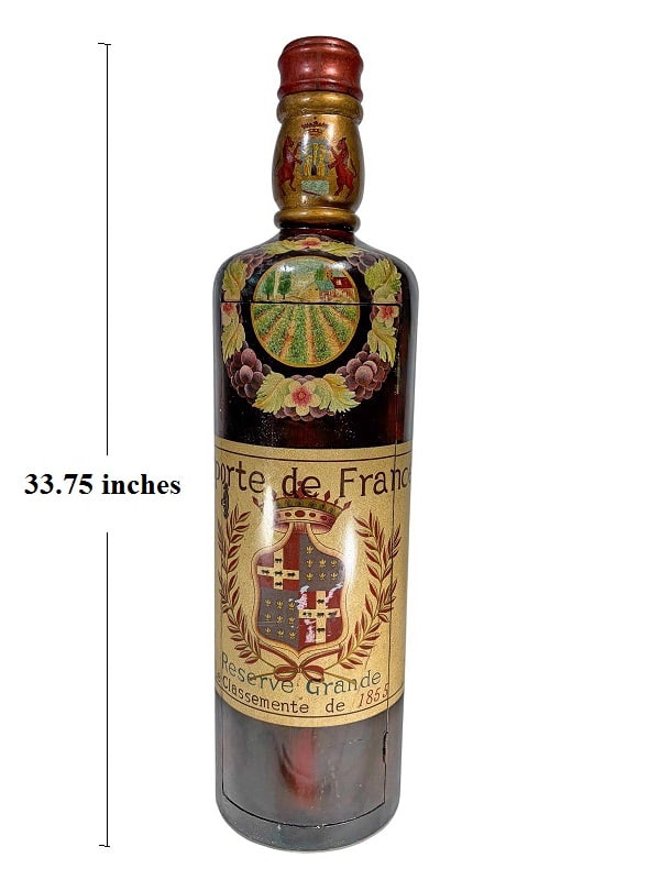 Bombay Co. Large Wooden Wine Bar Cabinet 33" H: Large Bopmbany Co. decorative wooden bar cabinet shaped as an oversized vintage wine bottle, with a hand-painted crest, vineyard scene, and metallic accents. Label reads 'Importe de France Reserve Gra