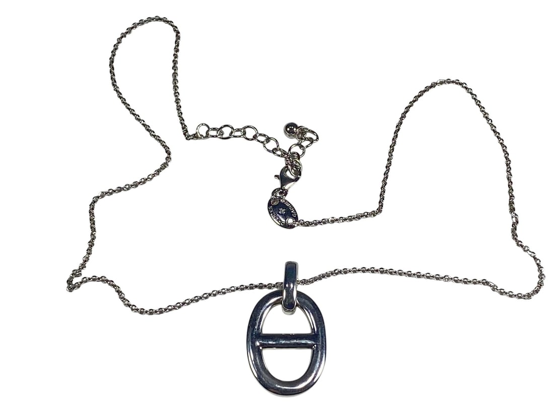Charles Garnier Sterling Silver Pendant Necklace: Charles Garnier sterling silver necklace, featuring a fine chain with a bold oval pendant accented by a central horizontal bar. The piece is hallmarked 925 and signed Charles Garnier. The total weight