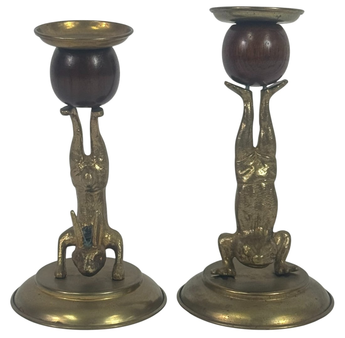 Pair of Arthur Court Brass Candlestick Holders: Pair of vintage Arthur Court Designs candlestick holders featuring playful figural forms cast in brass. One depicting a frog and the other of a rabbit, both performing acrobatic handstands. The figure