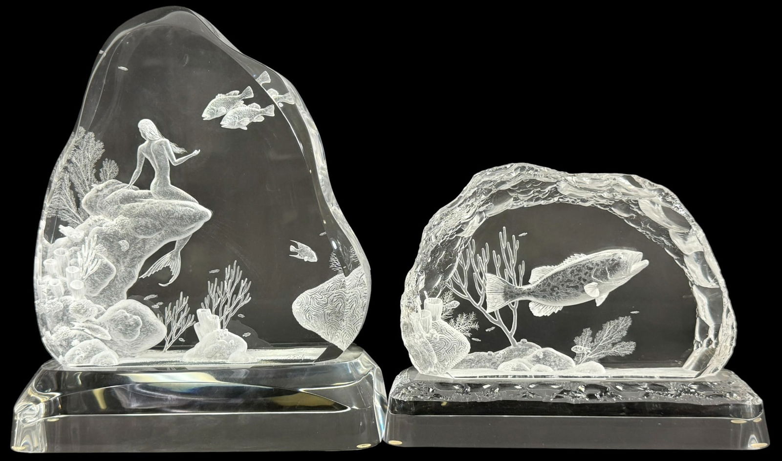 Two Lucite Acrylic Aquatic Sculptures by R. Rich: Lot of two R. Rich (20th century) contemporary acrylic Lucite sculptures featuring underwater scenes. The larger sculpture showcases a mermaid gracefully posed among coral and tropical fish, with intr