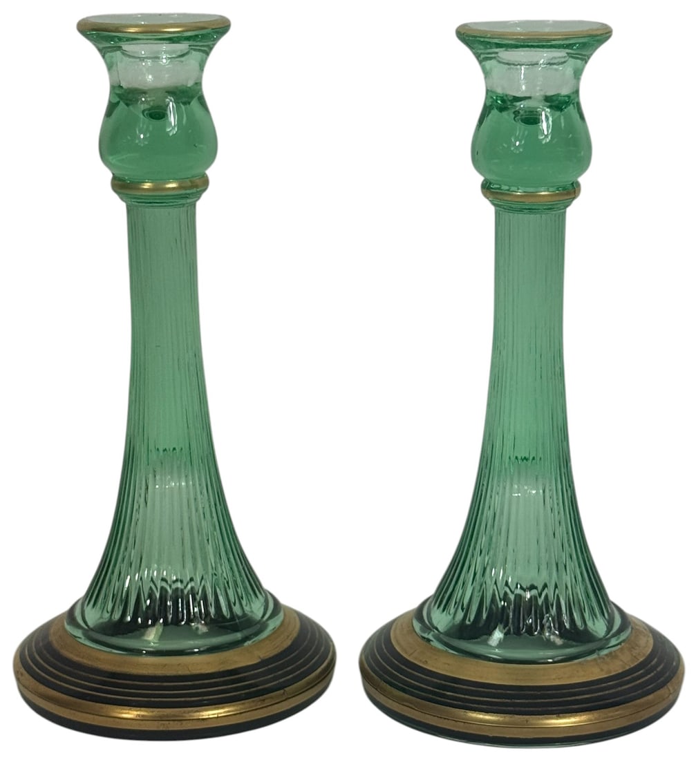 Pair of Ribbed Uranium Glass Enameled Candlesticks: Pair of vintage deco-style ribbed green uranium glass candlestick holders featuring an elegant flared form and tapered silhouette. Each candlestick is accented with hand-enameled gilt and black bands