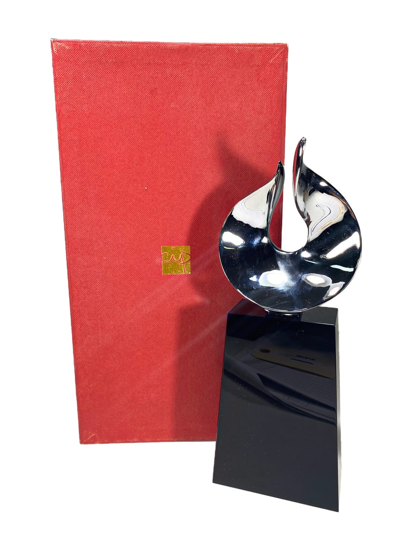 CIP Oasis Chrome & Black Crystal Sculpture: CIP modernist abstract sculpture with a polished chrome flame-form mounted on a tapered black crystal base. Presented in its original red case with gold CIP logo. The sculpture features its original m