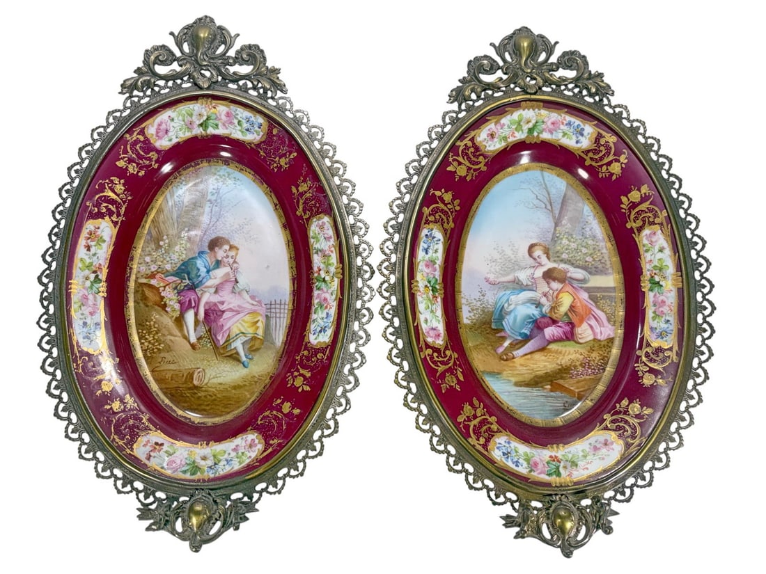 Antique Pair French Sevres Porcelain Bronze Trays: Antique pair of oval Sevres-style porcelain trays in ornate bronze frames, each hand-painted with courting figures on burgundy grounds with floral gilt borders, signed. Backs are marked with interlace