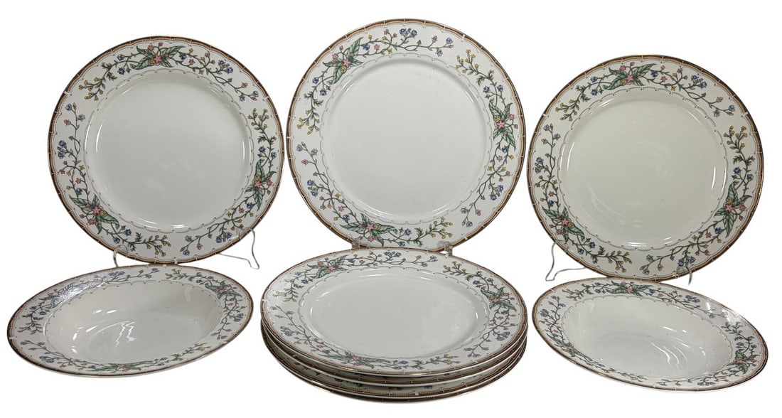 Katherine Babanovsky Farberware Wellesley 9pc LOT: Nine white porcelain plates in Farberware's Wellesley pattern, with multicolor floral garland borders and gold-accented geometric rim trim. Includes seven dinner plates and two shallow bowls. Undersid