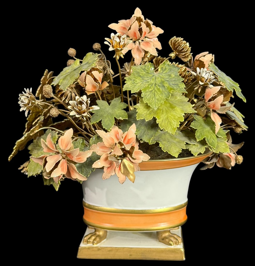 French Tole Floral Arrangement w/ Porcelain Bowl: 20th century French handcrafted tole floral arrangement featuring enameled metal flowers and foliage in shades of green, peach, and gold. The bouquet is set in a porcelain footed bowl with orange and
