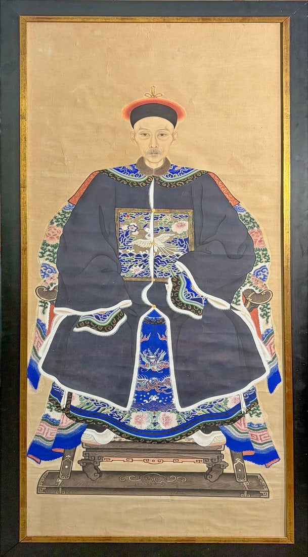 Chinese Mandarin Portrait Painting on Paper: Traditional Chinese ancestor portrait depicting a seated mandarin official in embroidered court robes, painted in mineral pigments and ink on paper, in a modern black frame with gold liner.Work Size: