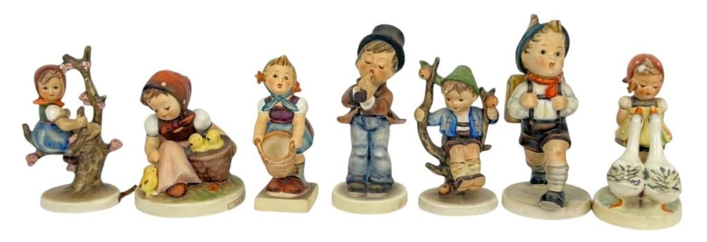 Goebel Hummel Porcelain Figurines 7pc Collection: Lot of seven Goebel Hummel porcelain figurines, each depicting children in charming poses. Each piece is hand-painted in soft colors, with their Goebel and Hummel stamp marks are present underneath th