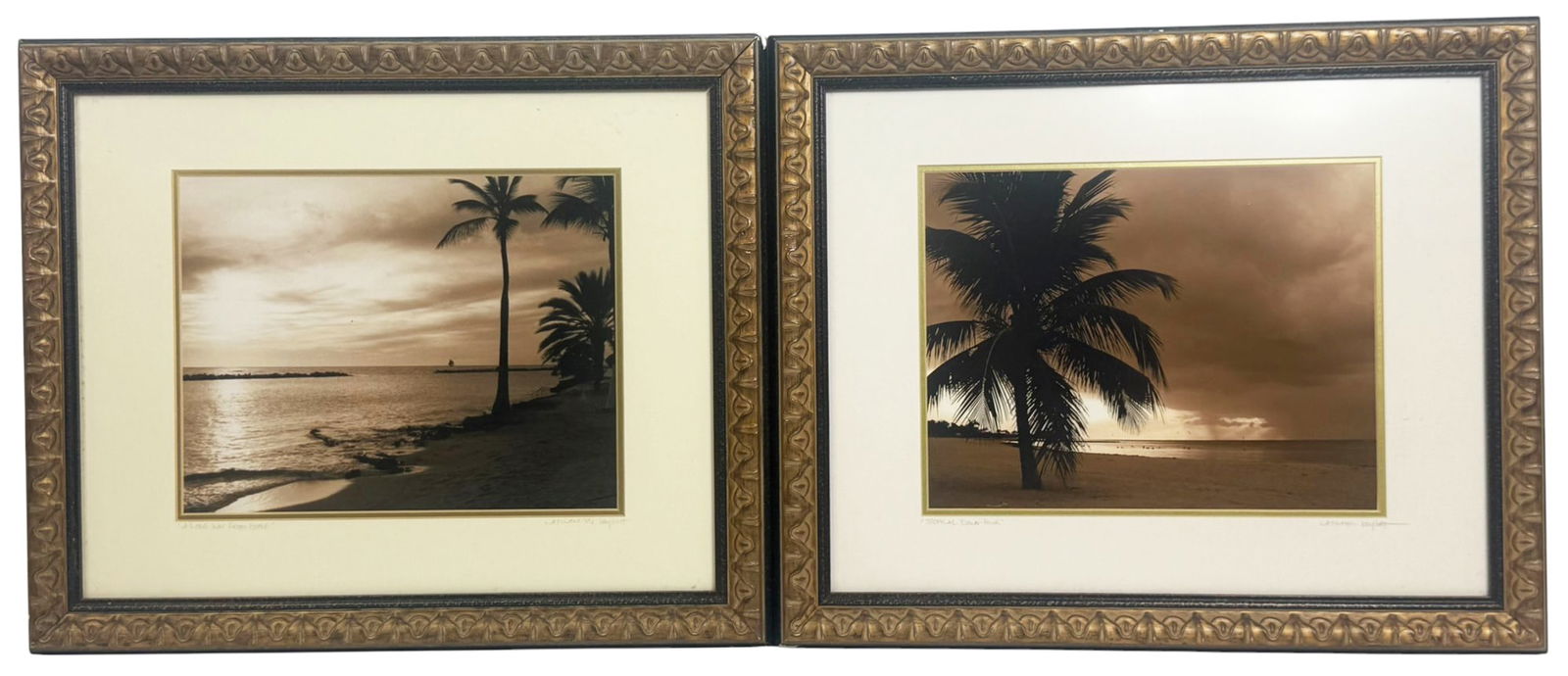 Pair of Sepia Key West Beach Photographs by Latham: Pair of sepia-toned photographic prints capturing tranquil tropical beach scenes, each featuring a solitary palm tree silhouetted against expansive skies. Titled 'A Long Way From Home' and 'Tropical