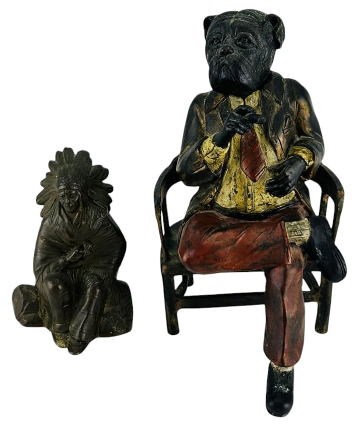 Bronze Bulldog Cigar Smoker & Indian Chief Bust 2p: Includes two cast bronze metal figures. One depicts a seated bulldog figure on an armchair holding a cigar. The other represents a Native American Indian chief figure with feathered headdress holding