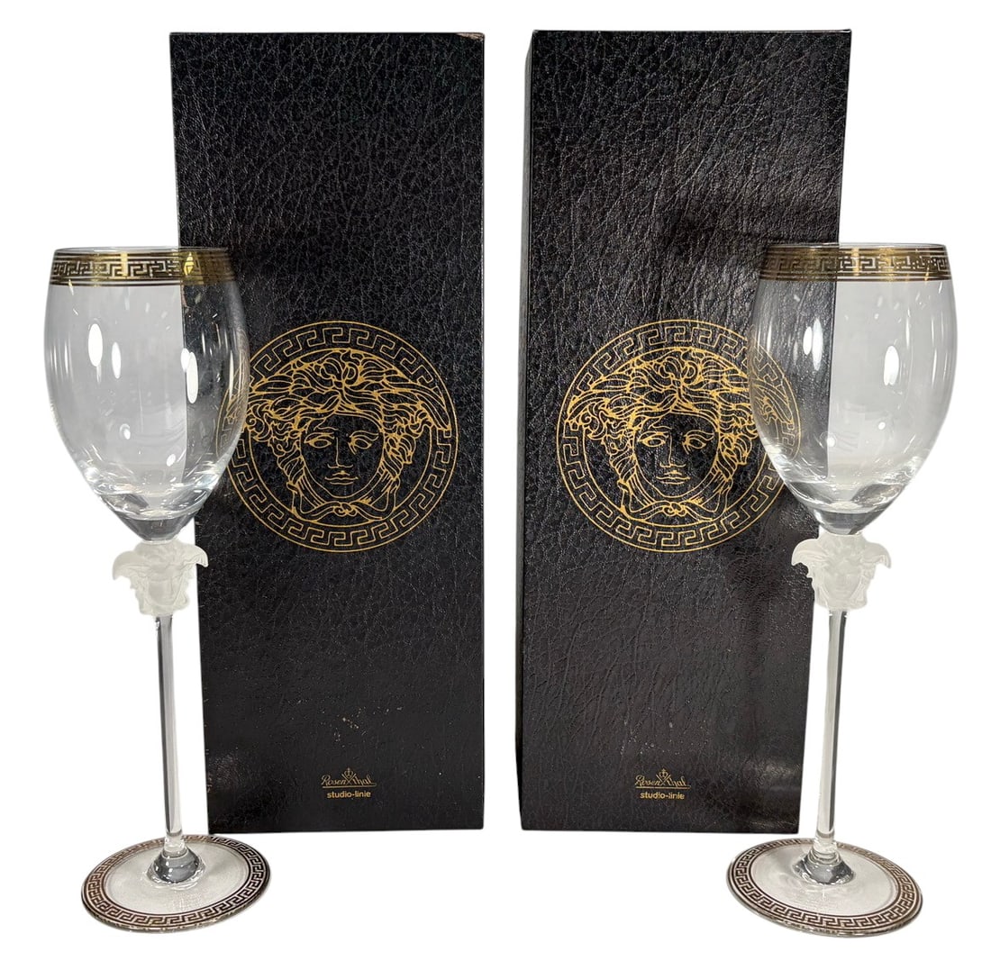 Rosenthal Versace Medusa D'Or Wine Glasses 2pc LOT: Pair of Rosenthal for Versace Medusa d?Or white wine glasses with clear bowls, gilt Greek key meander trim, and frosted Medusa head stems. Rosenthal Studio Linie. Etched base reads Rosenthal