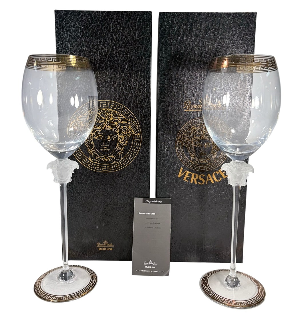 Rosenthal Versace Medusa D'Or Red Wine Glass 2pcs: Rosenthal for Versace pair of Medusa d'Or red wine glasses, crafted in Germany under Rosenthal Studio Linie. Each features a clear bowl with frosted Medusa head stem and gilt Greek key trim at the foo