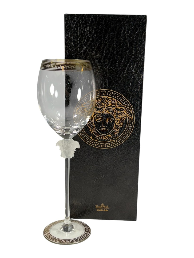 Rosenthal Versace Medusa D'Or Red Wine Glass: Single Rosenthal for Versace Medusa d'Or red wine glass, made in Germany. Frosted Medusa head stem with clear bowl and gold and black Greek key trim at rim and foot. Etched base reads Rosenthal studio