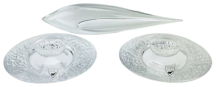 Orrefors Discus Candleholder PR & Kosta Boda Fish: Lot of two Mid Century Modern Scandinavian clear glass items. Includes a pair of Orrefors clear textured glass candle holders in the Discus pattern designed by Lars Hellsten (Swedish, 1964-2022). Feat