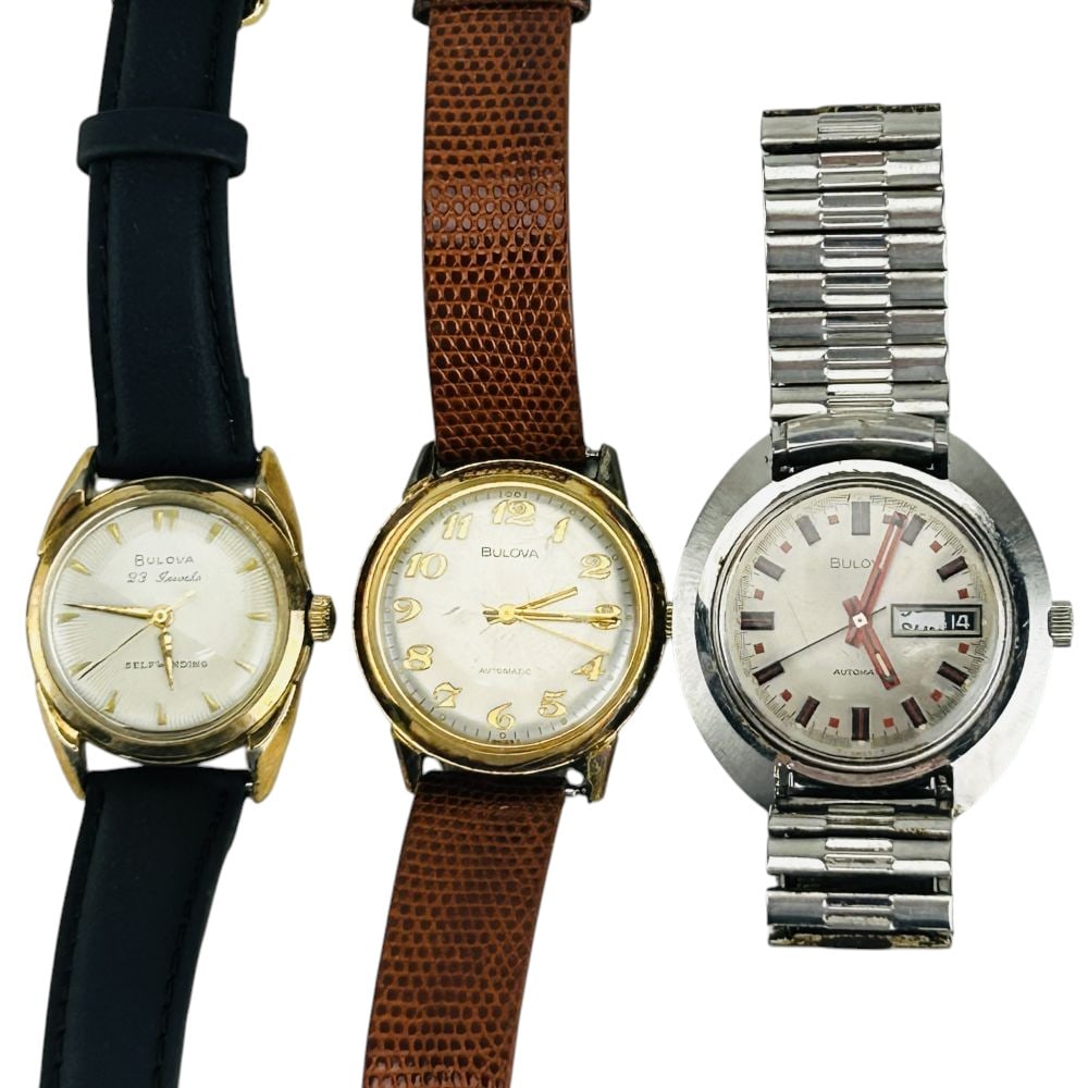 Bulova Automatic & Self Winding Men's Wristwatches: Estate lot of three Bulova wristwatches. Includes a Jet Star model with stainless case, date display window, red sunburst dial accented by a black chapter ring and applied markers, verso monogrammed w