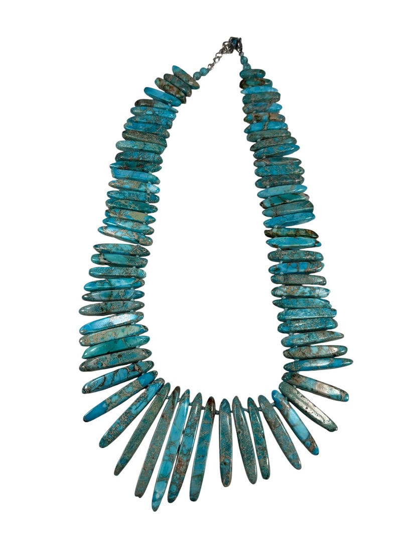 Native American Navajo Turquoise Necklace: Navajo hand strung turquoise necklace with graduated spike beads and natural matrix. Silver tone extender chain and lobster clasp. The necklace measures 19.5 inches long and 2.25 inches
