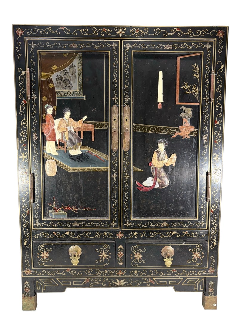Chinese Black Lacquer Natural Stone Inlaid Cabinet: Chinese black lacquer cabinet with natural stone inlays depicting interior and garden scenes, with gilt floral decoration, two doors over drawers with brass hardware, and block legs with brass