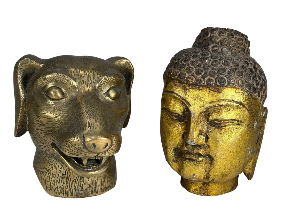 Chinese Zodiac Dog Bronze & Stone Buddha Heads: Pair of sculptural heads including a bronze Chinese zodiac dog head with incised fur details and character mark, and a carved stone Buddha head with worn polychrome and serene features. The tallest