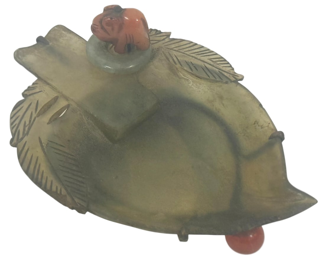 Chinese Hand-Carved Jade & Coral Leaf Form Tray: Chinese hand-carved jade tray in the shape of a leaf, accented with a charming coral animal figure (possibly a mythical beast or stylized dog) perched on a raised platform. The tray features