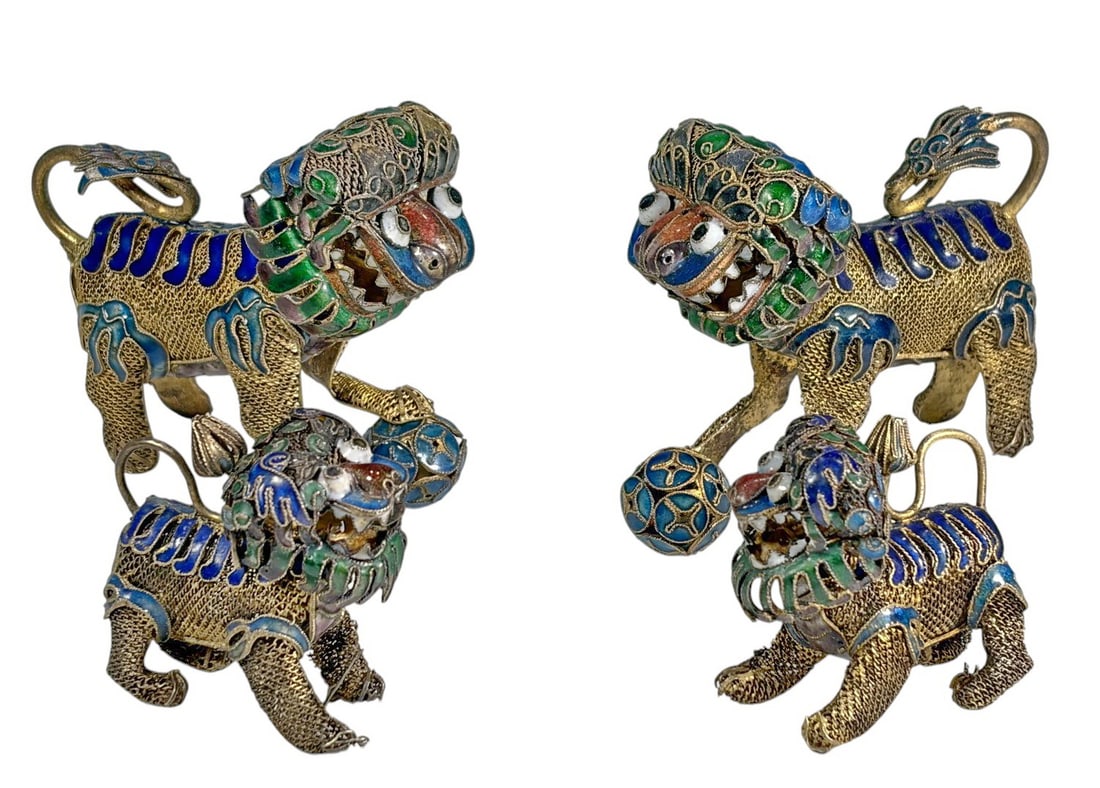 Chinese Export Filigree & Enamel Foo Dogs 4pc LOT: Four Chinese Export gilt metal Foo Dogs with intricate filigree work and blue, green, and red enamel decoration, each modeled with a paw on a pierced enamel ball. The largest measures approximately
